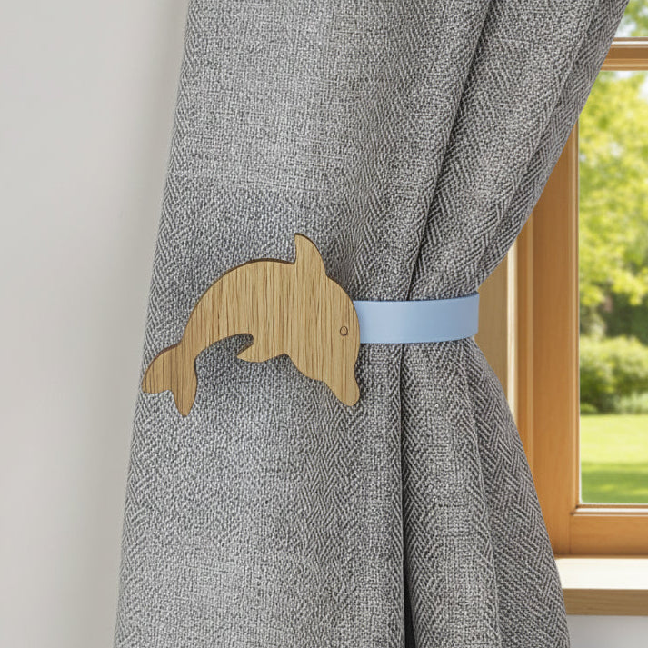 Gray curtain with a wooden dolphin-shaped curtain tieback
