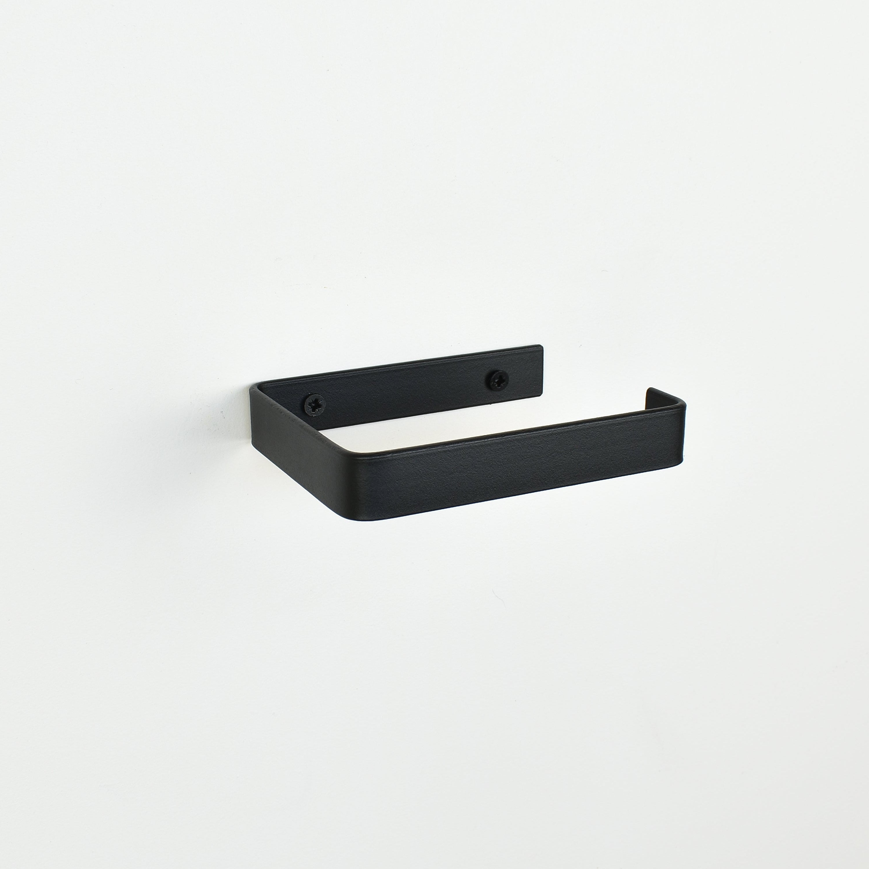 Matt black steel toilet roll holder showing fixing left angle bathroom hardware