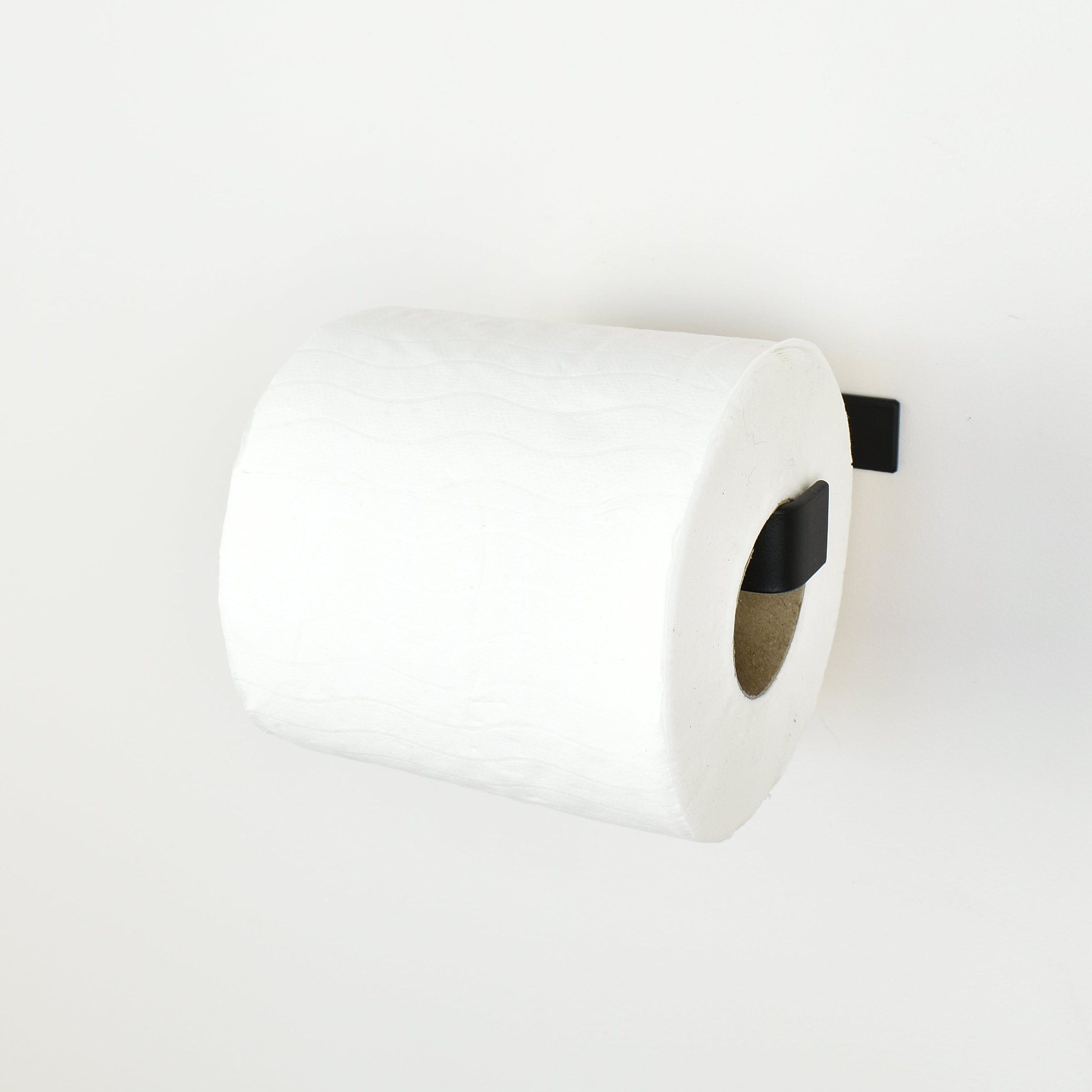 Black steel toilet paper holder right view showing toilet paper roll 