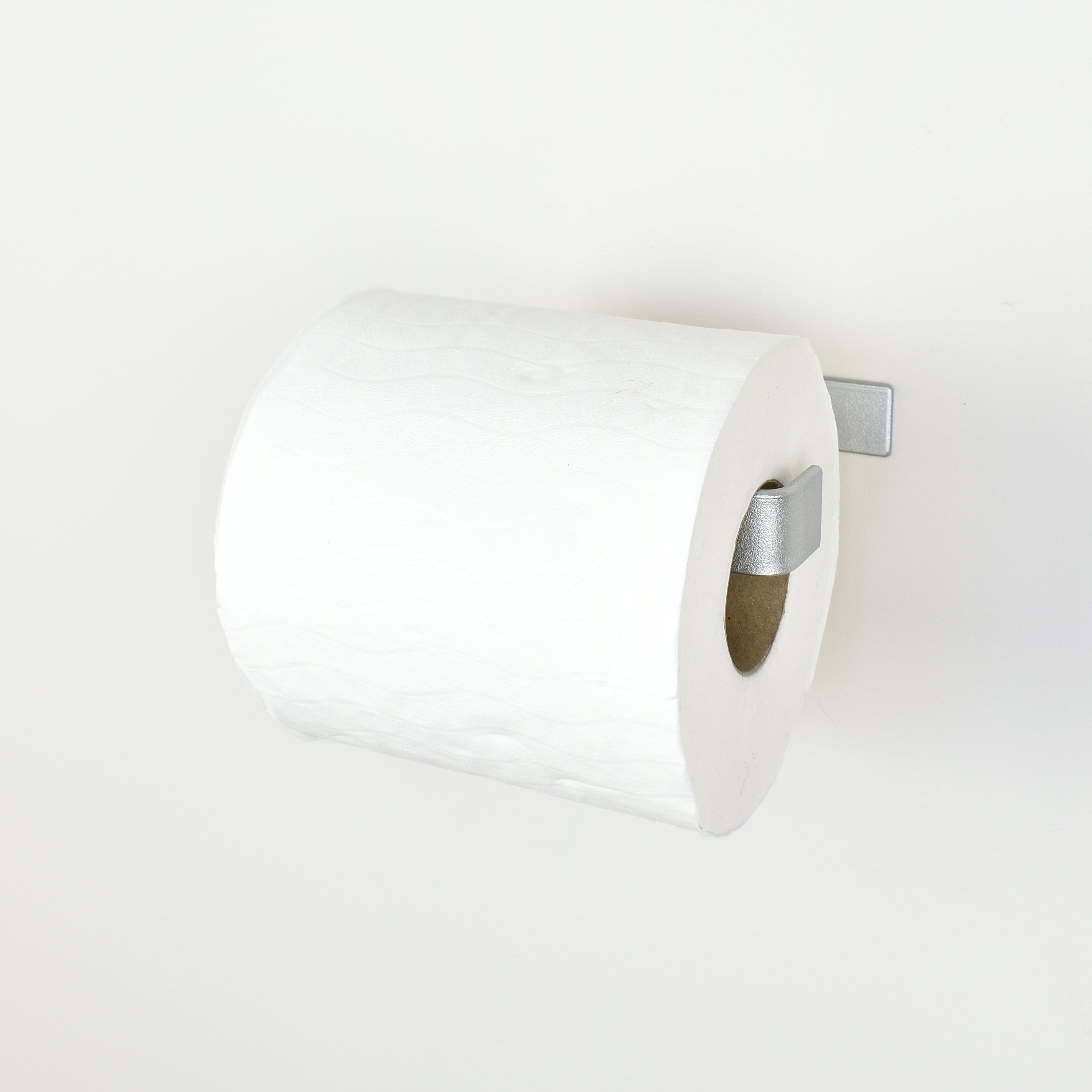 Metallic silver steel toilet paper holder right view showing toilet paper roll 