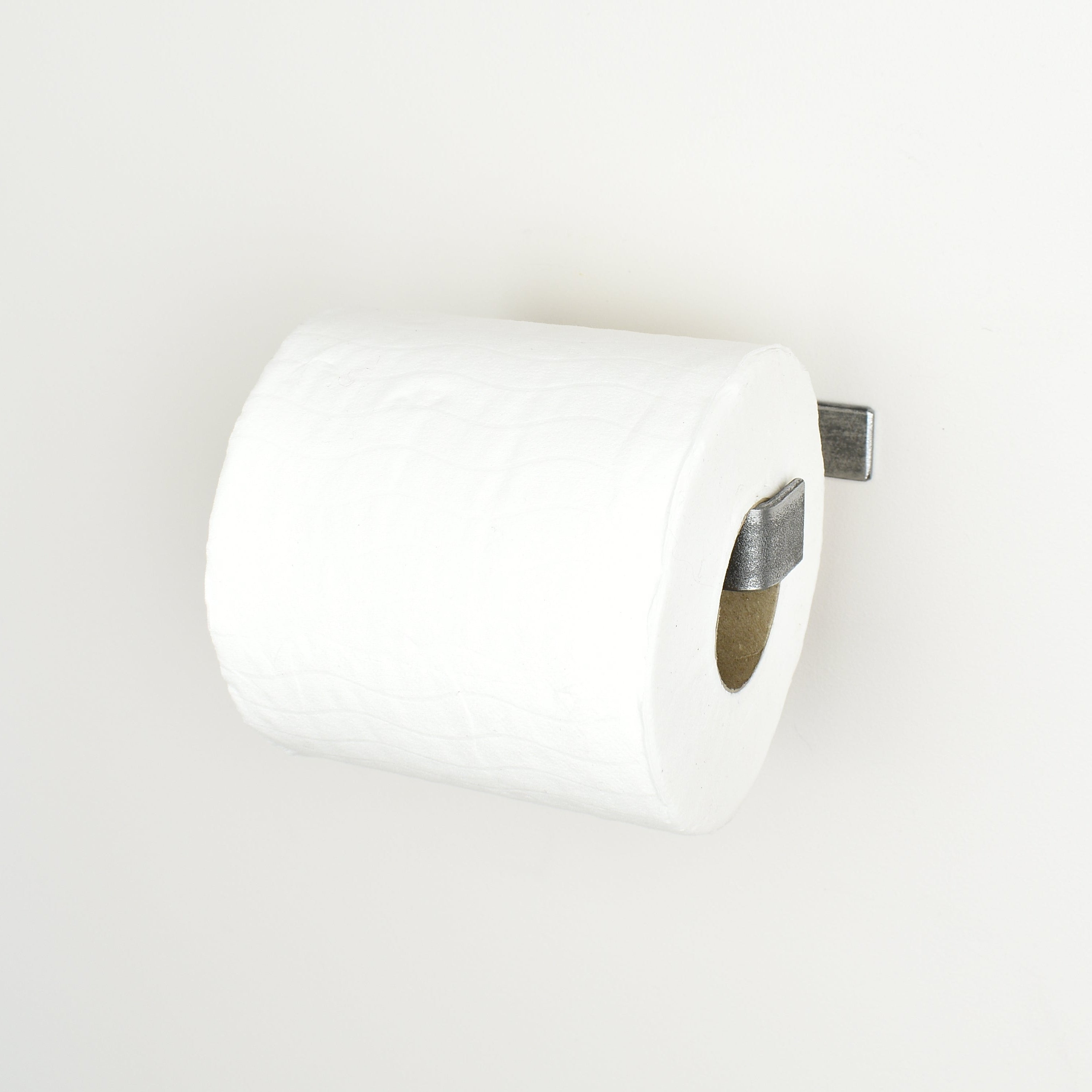 Pewter metal toilet paper holder right view showing toilet paper roll 