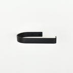 rounded edge black metal toilet roll holder with a white background - front view
