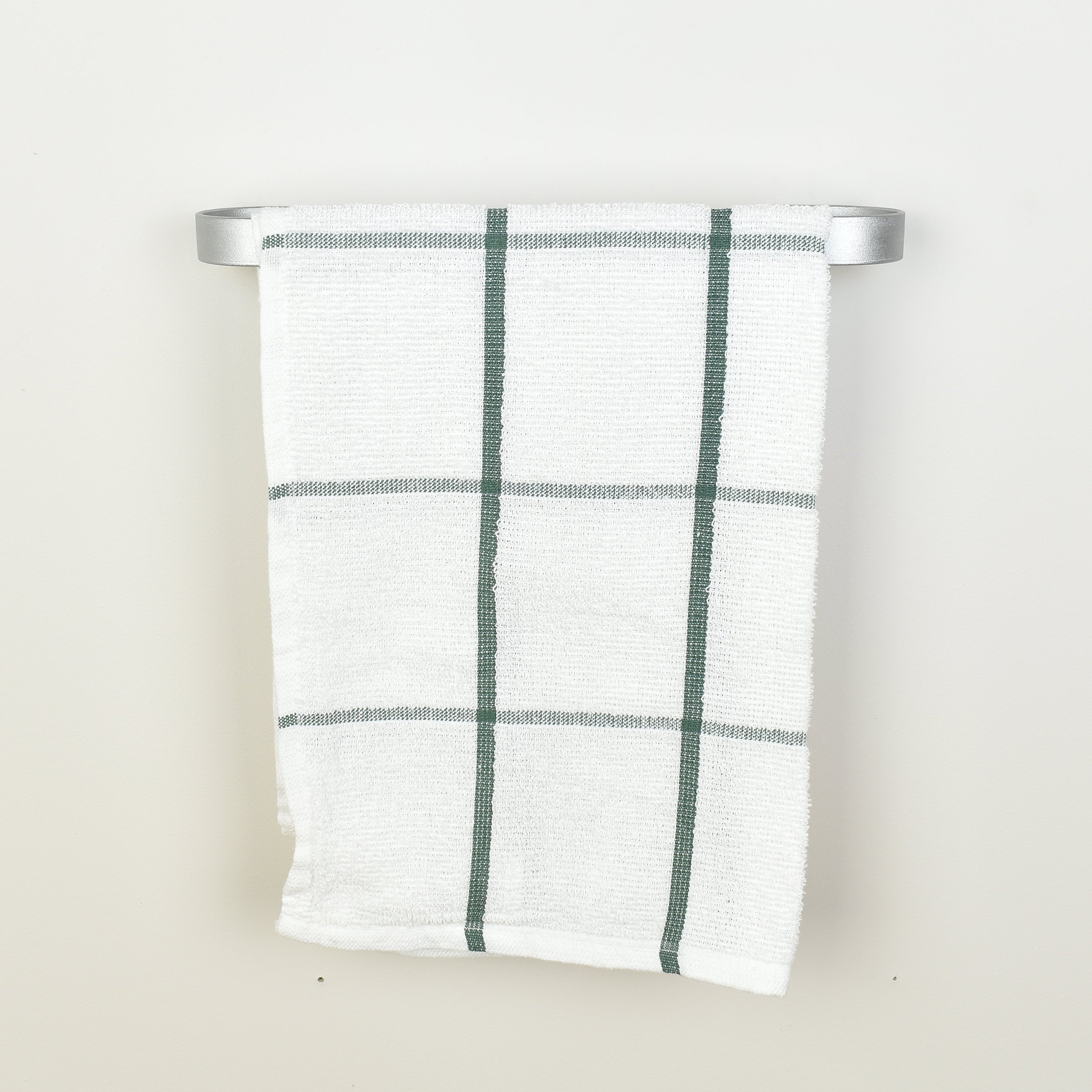 Plaid towel hanging on a silver towel rack against a white background - front view