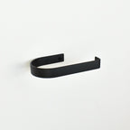 rounded edge matte black metal toilet roll holder with a white background - left view