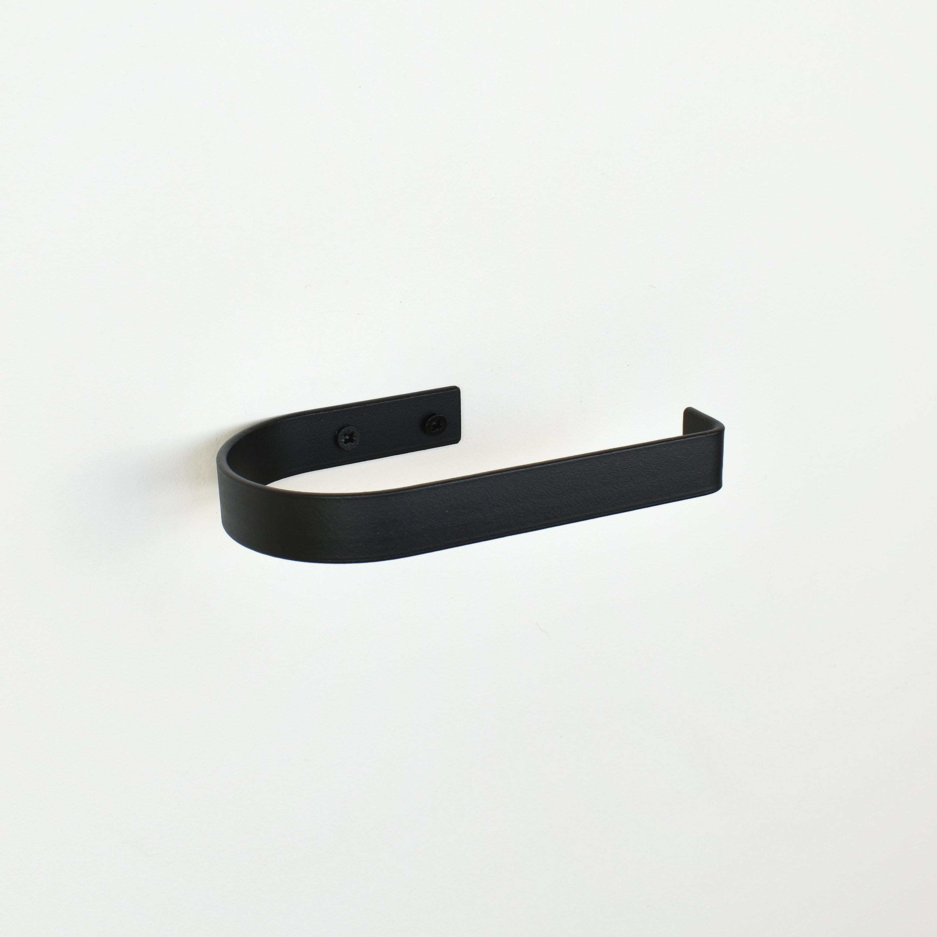 rounded edge matte black metal toilet roll holder with a white background - left view