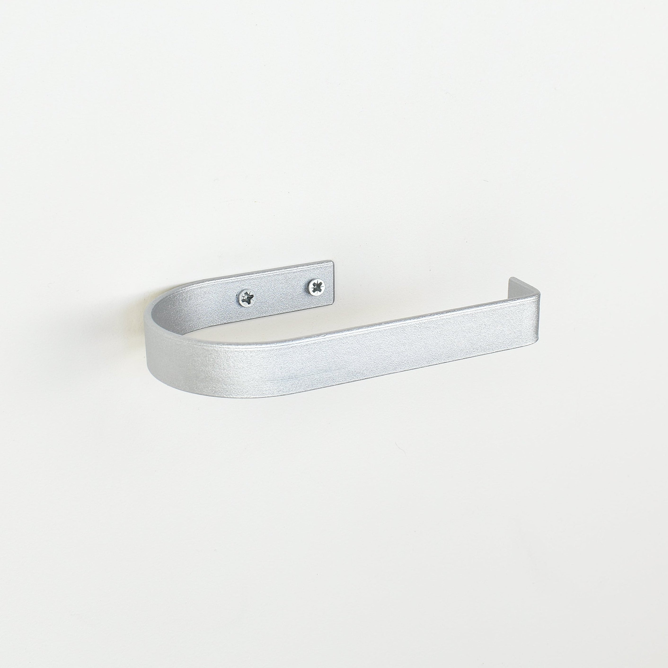 rounded edge silver metal toilet roll holder with a white background - left view