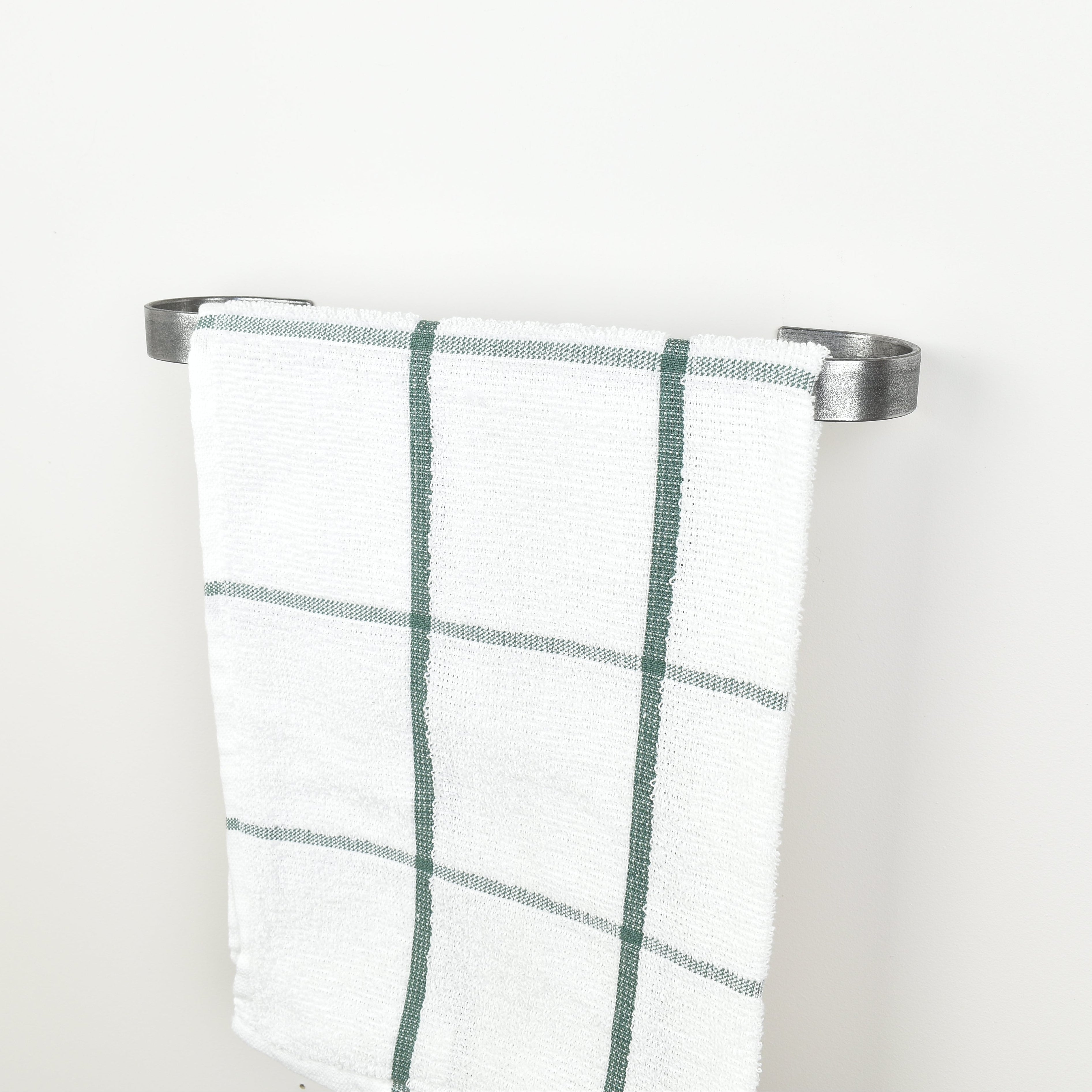 Plaid towel hanging on a pewter towel rack against a white background - right view