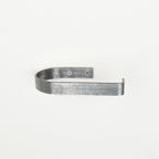 rounded edge pewter metal toilet roll holder with a white background - front view