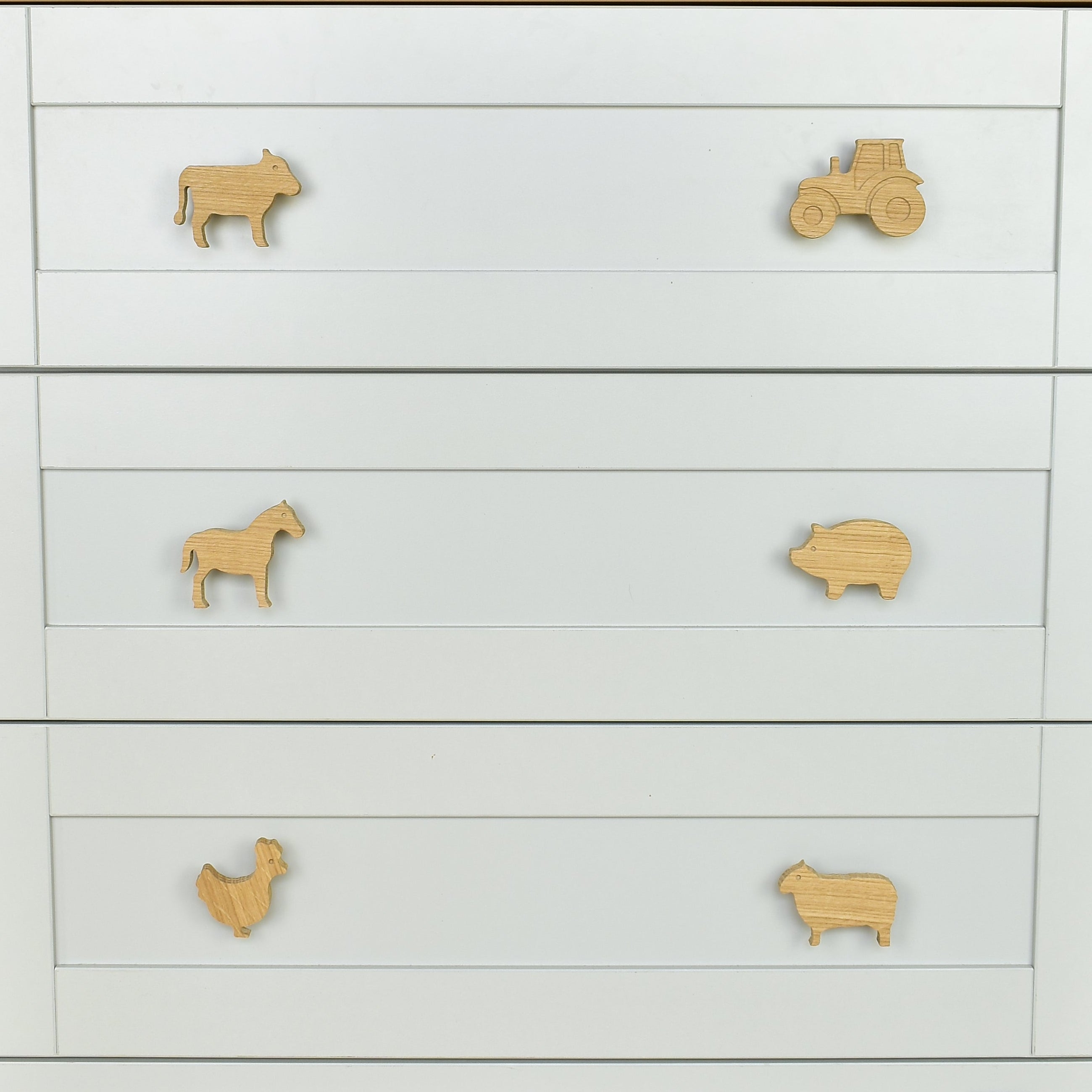 Farmyard oak drawer handles close-up front view - tractor cow horse pig chicken sheep kids nursery decor 