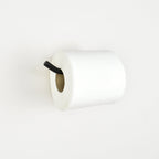 White toilet paper roll on a black metal toilet paper bar with white background