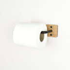 wall mounted toilet paper holder with wooden finish and black metal bar on a white background