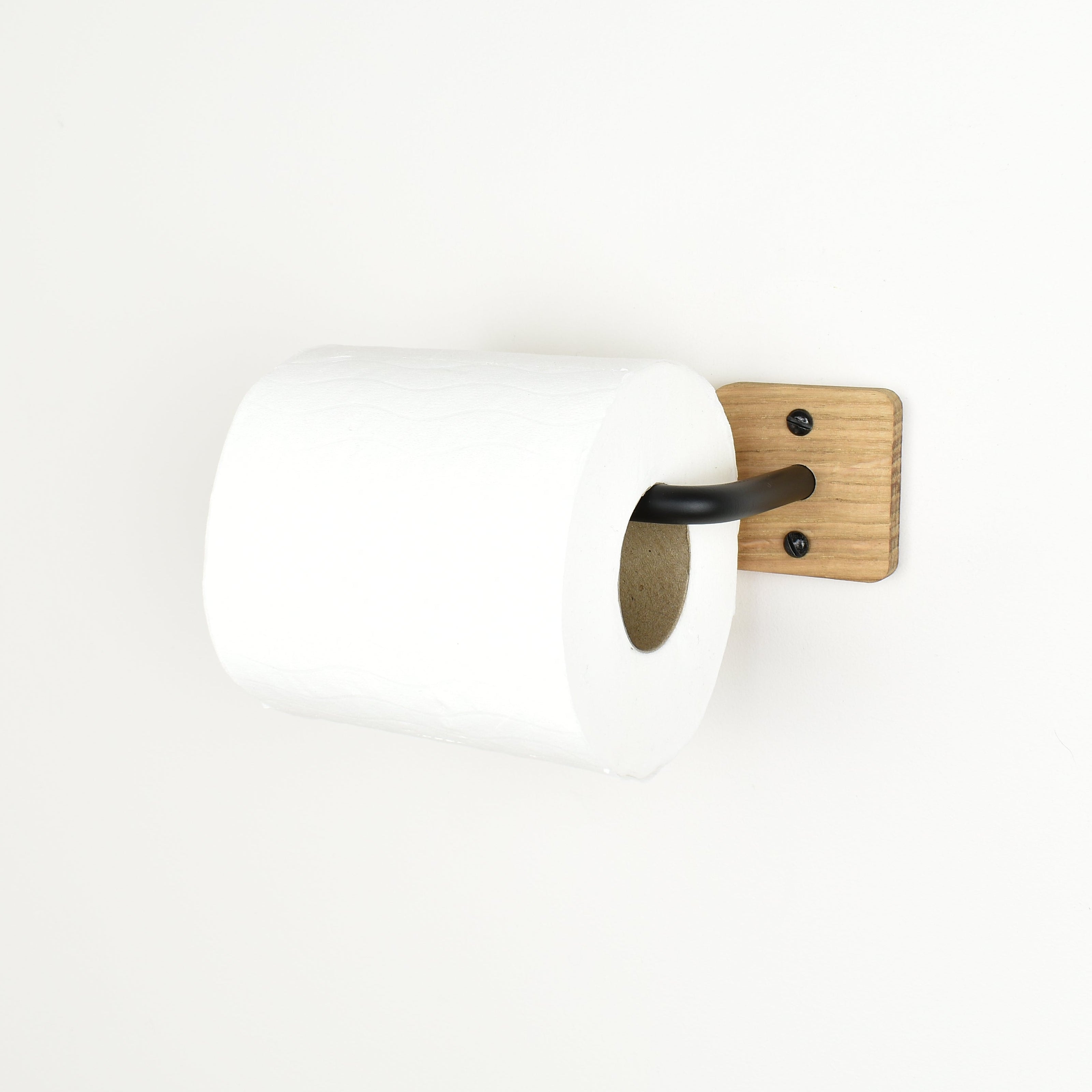 wall mounted toilet paper holder with wooden finish and black metal bar on a white background