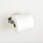 roll of toilet paper on a pewter metal toilet roll holder - left view