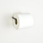 white toilet paper on a pewter toilet roll holder bar with a white background