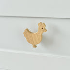 Oak chicken drawer knob fitted to a white chest of drawers showing natural wood grain