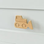Oak bulldozer drawer knob fitted to a white chest of drawers showing natural wood grain