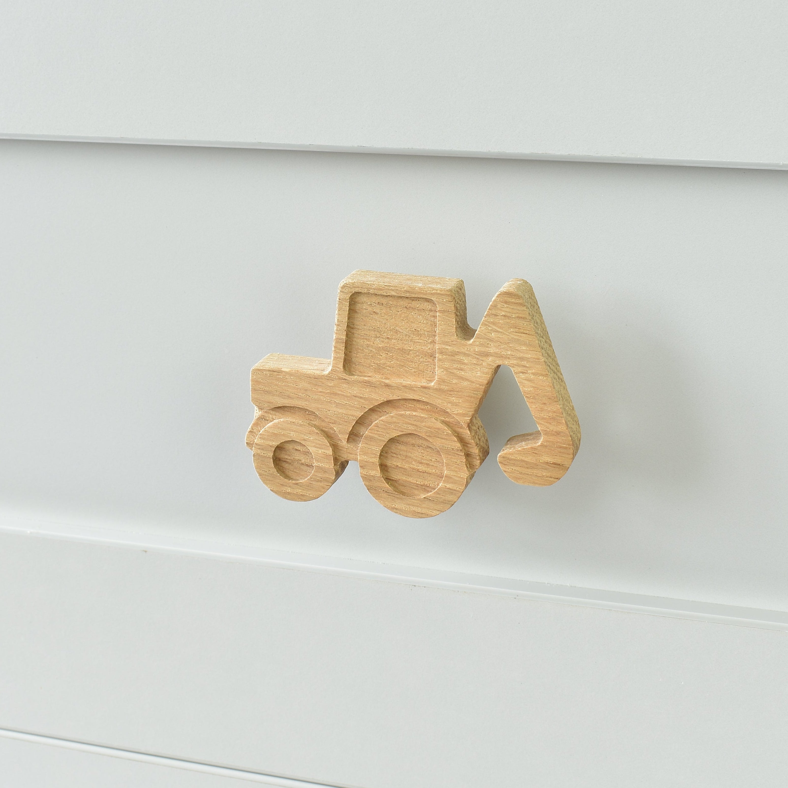 Oak digger drawer knob fitted to a white chest of drawers showing natural wood grain