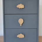 Oak cloud and hot air balloon drawer knobs fitted to a blue chest of drawers