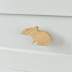 Oak mouse drawer knob fitted to a white chest of drawers showing natural wood grain