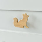 Oak fox drawer knob fitted to a white chest of drawers showing natural wood grain