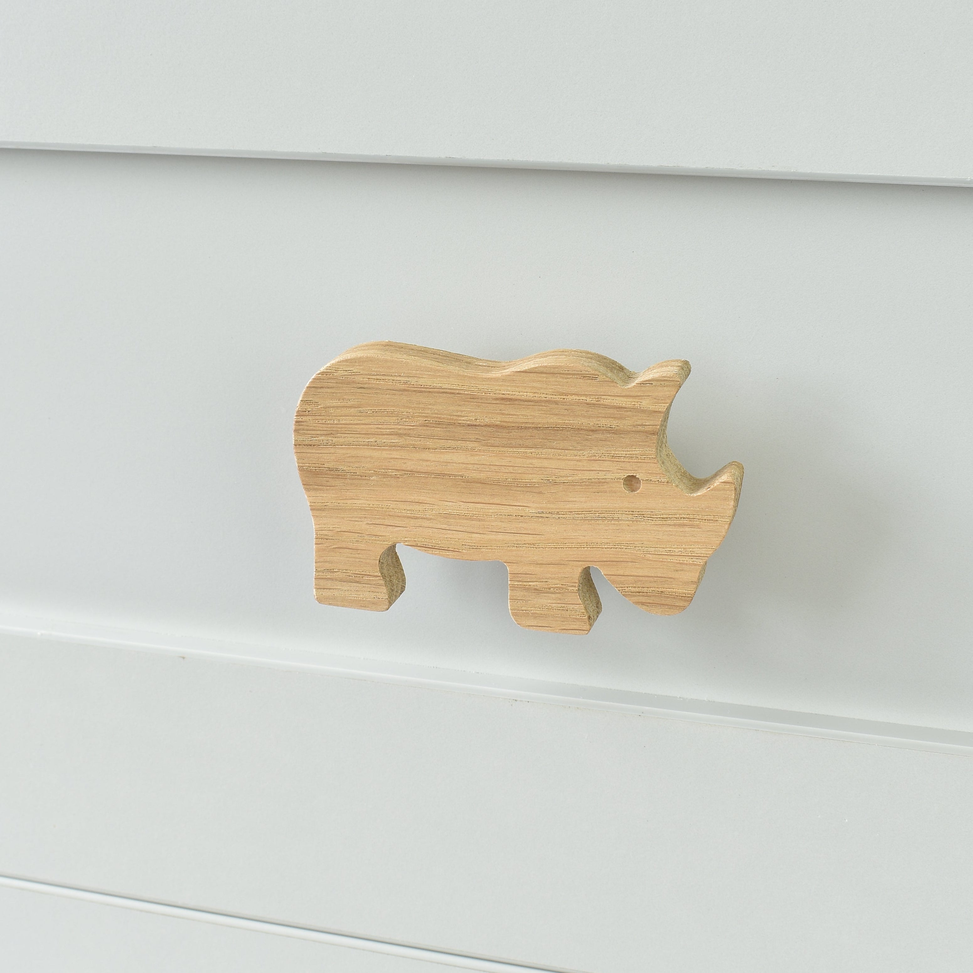 Oak rhino drawer knob fitted to a white chest of drawers showing natural wood grain
