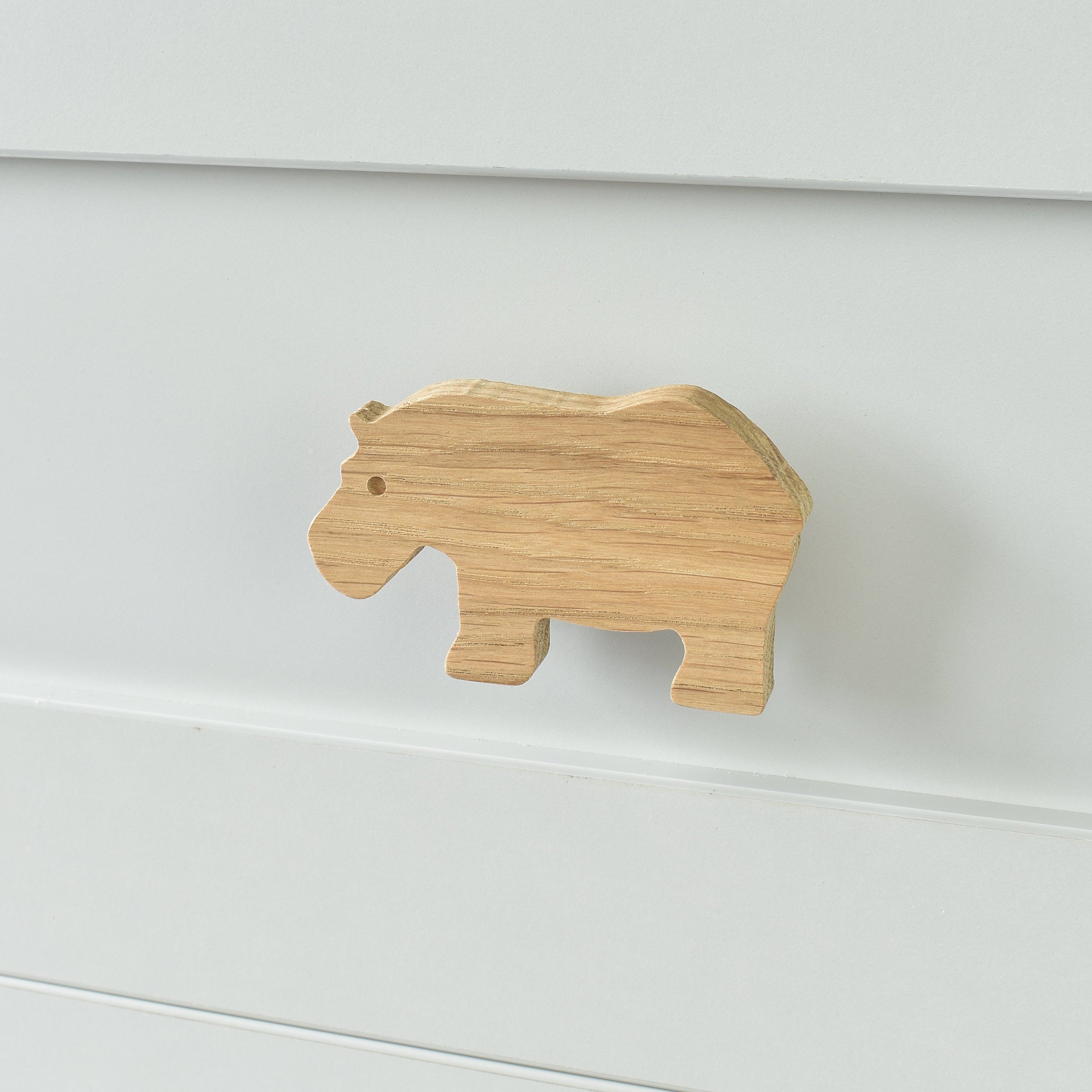 Oak rhino drawer knob fitted to a white chest of drawers showing natural wood grain