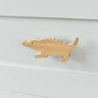 Oak crocodile drawer knob fitted to a white chest of drawers showing natural wood grain