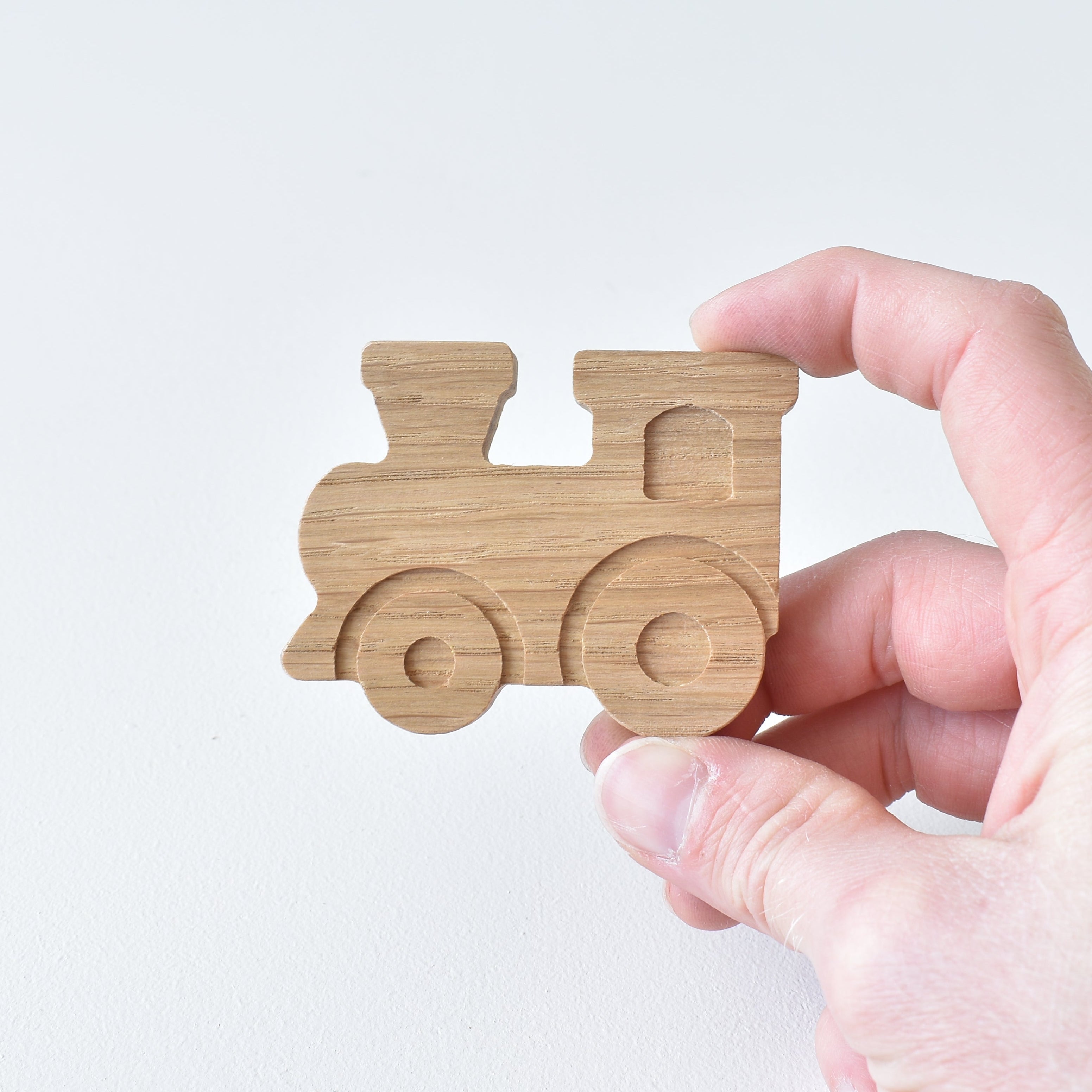 Back of oak truck drawer knob showing threaded insert and fixing screw