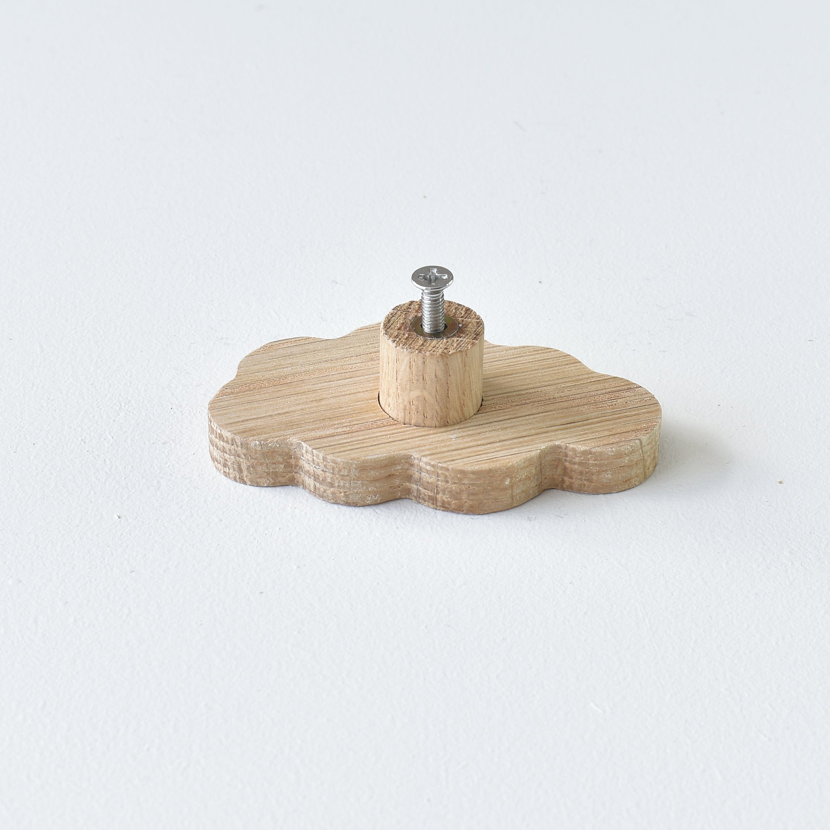 Back of oak cloud drawer knob showing threaded insert and fixing screw