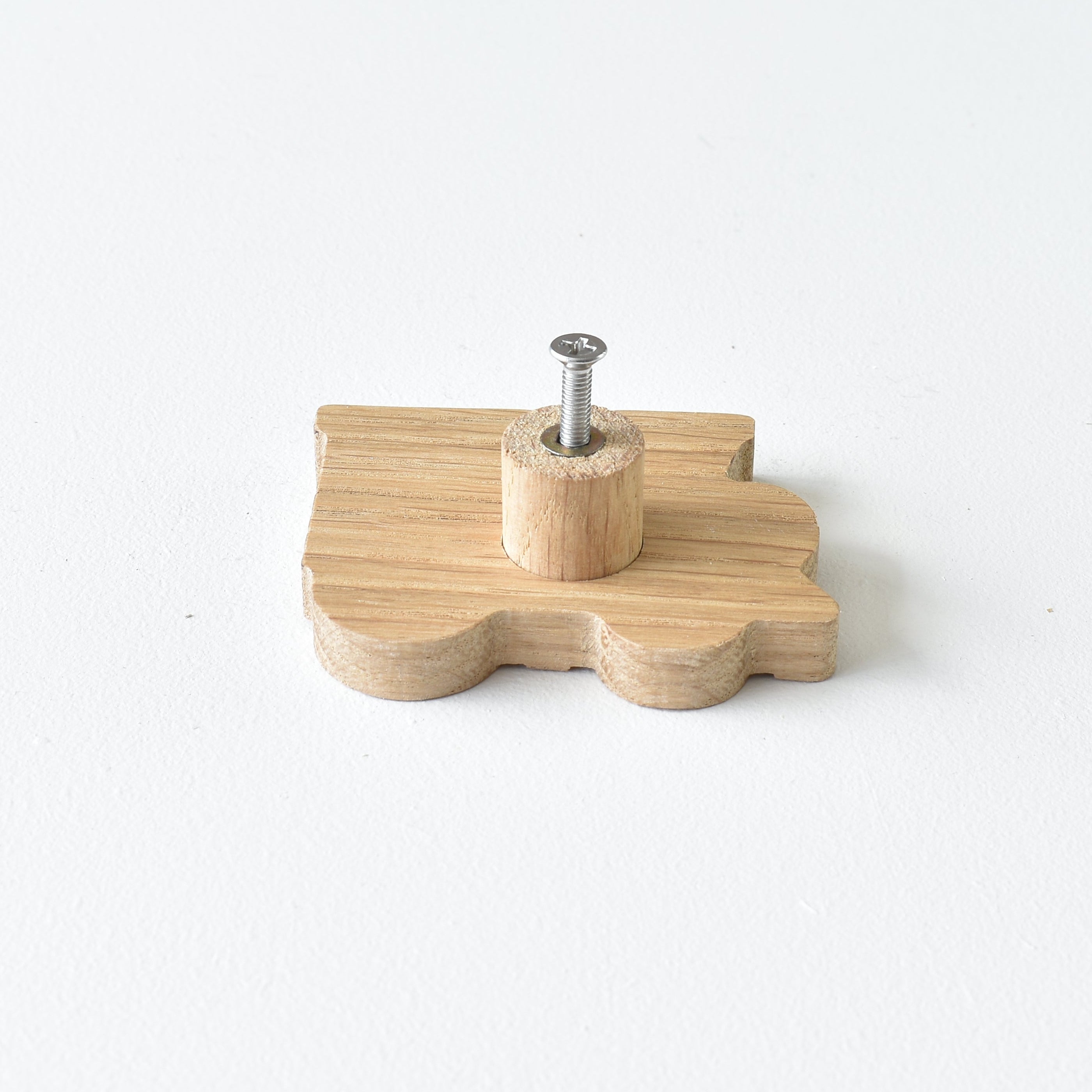 Back of oak truck drawer knob showing threaded insert and fixing screw