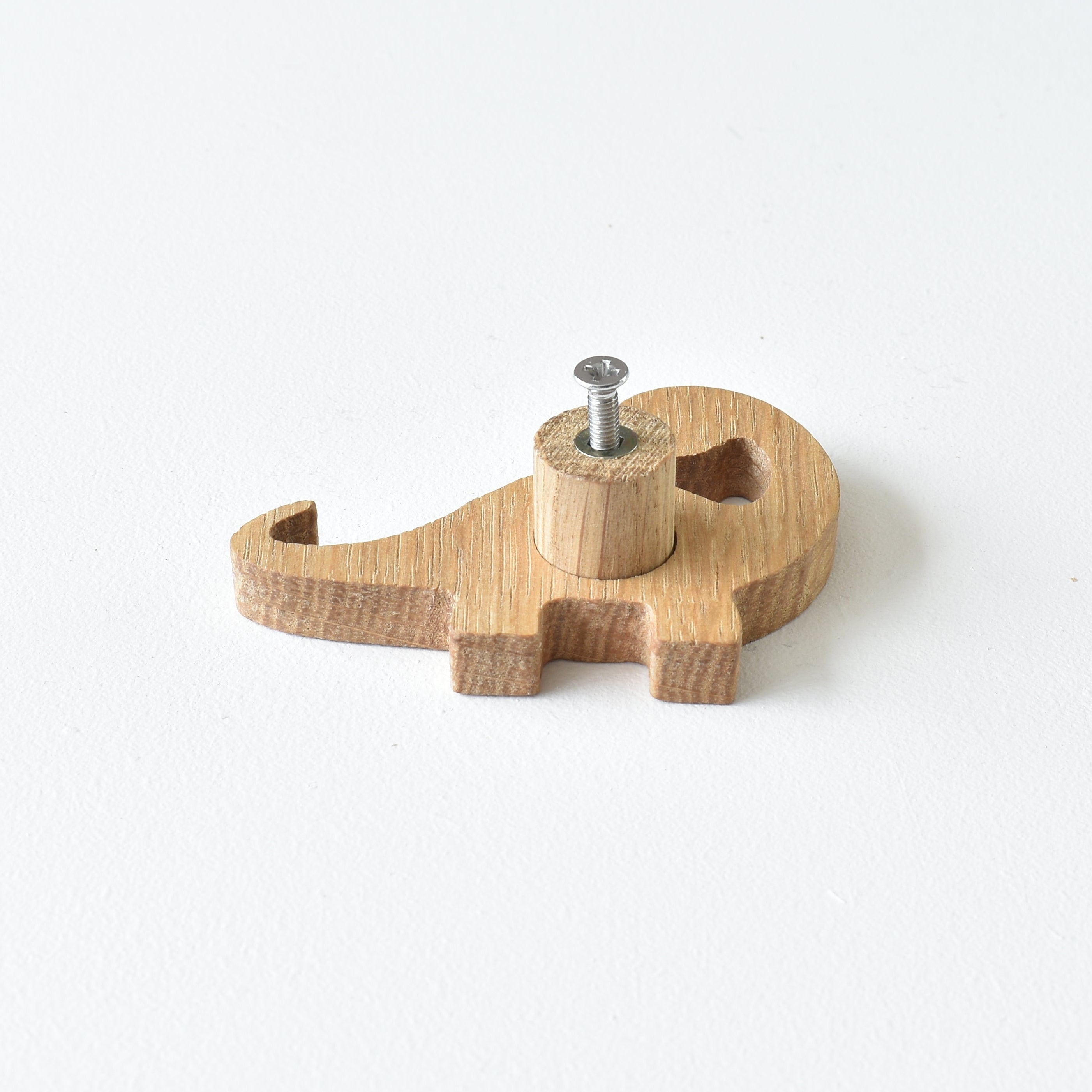 Back of oak dinosaur drawer knob showing threaded insert and fixing screw