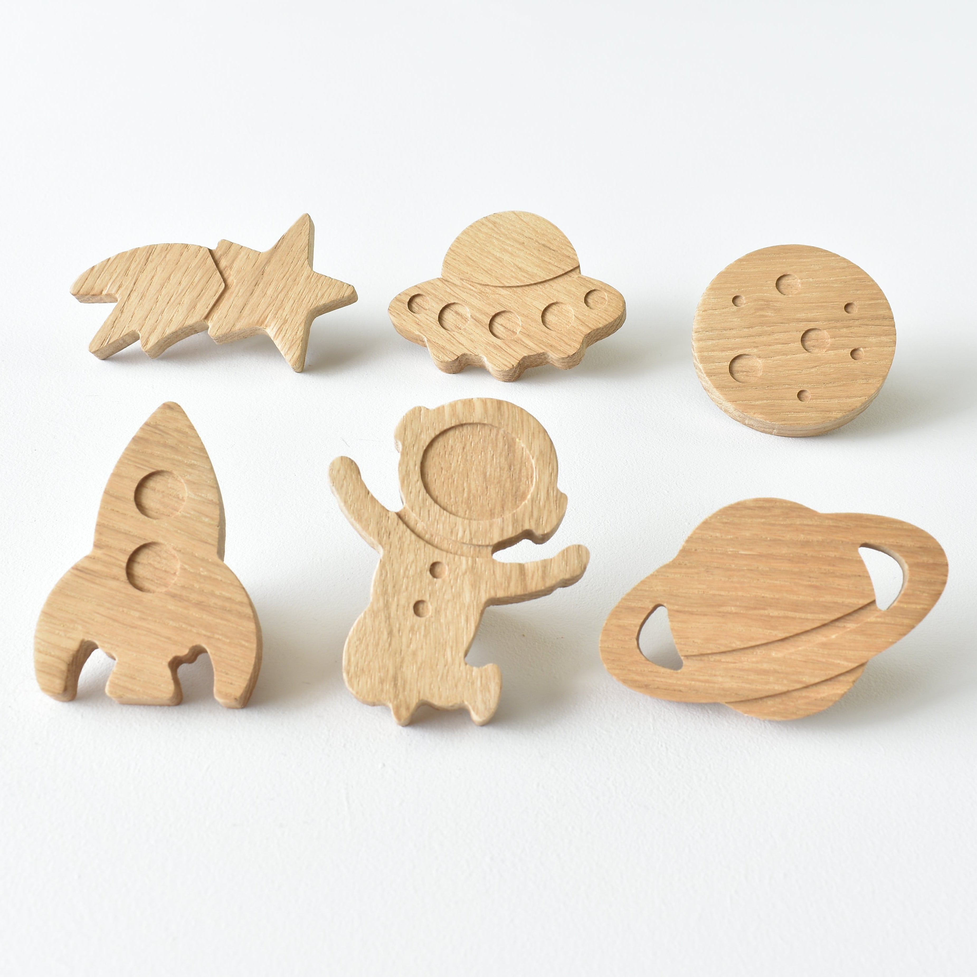 Set of six handmade oak space themed drawer knobs including rocket, astronaut, UFO, planet, moon and shooting star designs