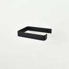 black metal toilet roll holder with a white background