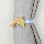 Wooden dolphin shaped curtain tieback