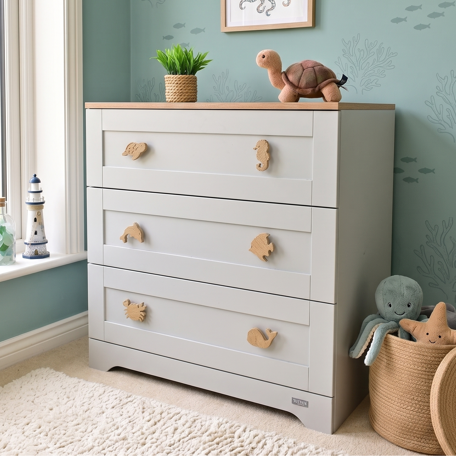 Oak ocean animal drawer knobs fitted to a white nursery chest of drawers in a children’s bedroom