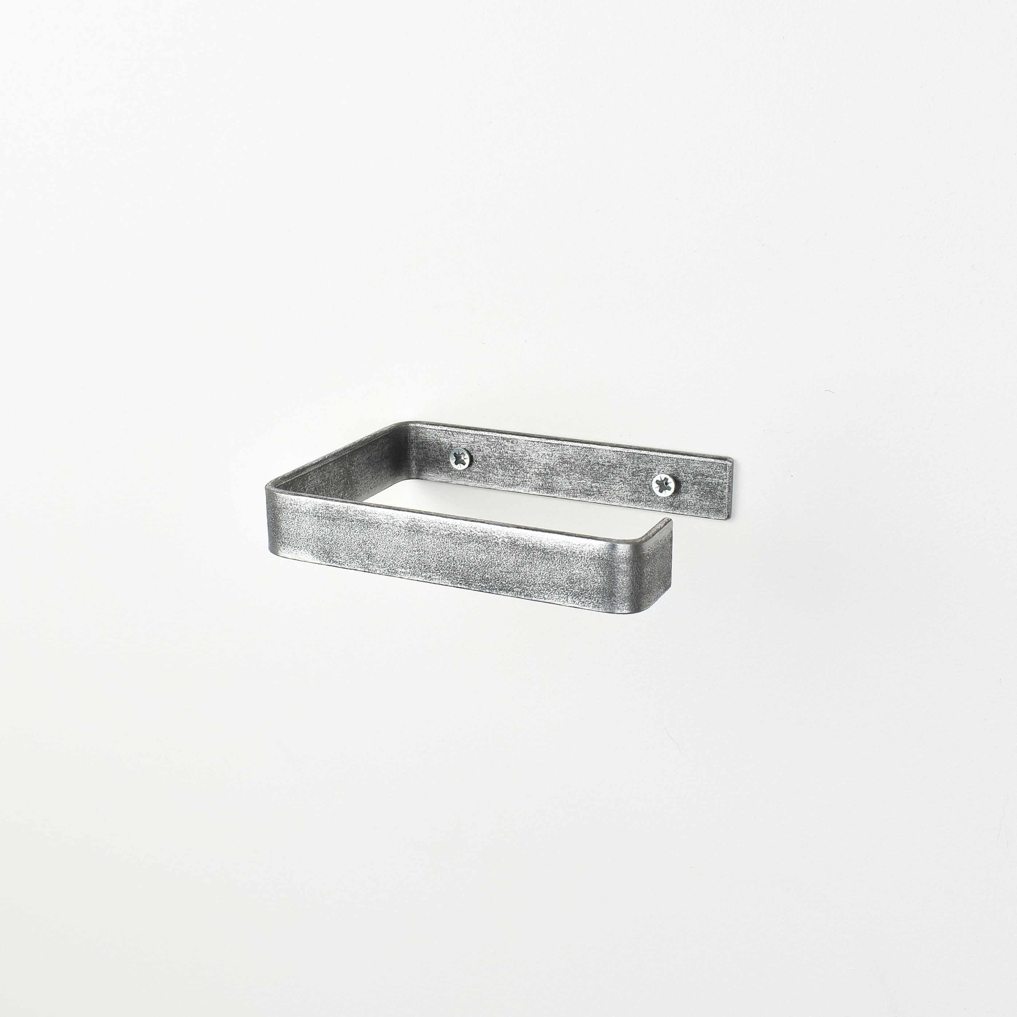 pewter metal toilet roll holder with a white background