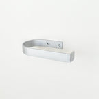 rounded edge silver metal toilet roll holder with a white background