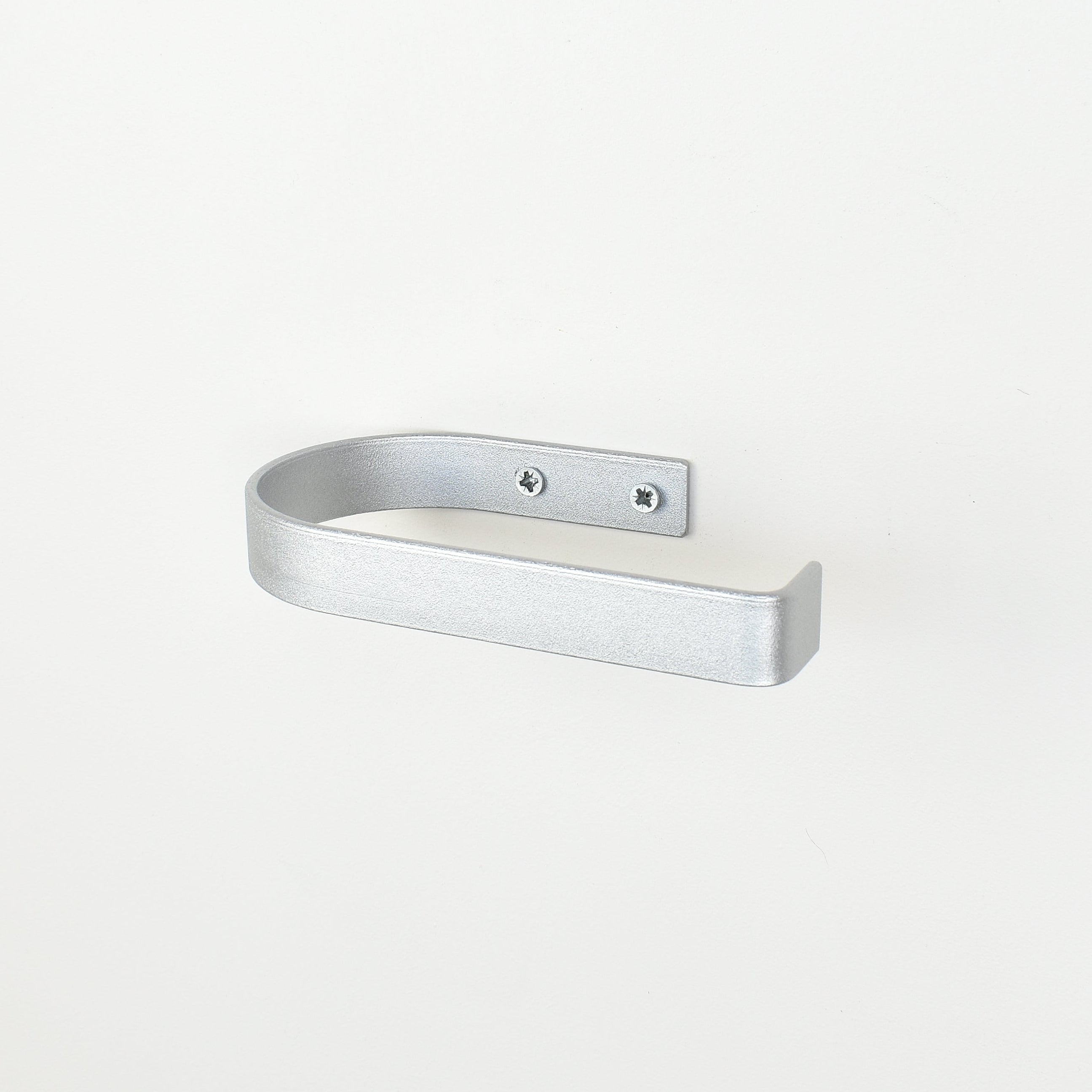 rounded edge silver metal toilet roll holder with a white background