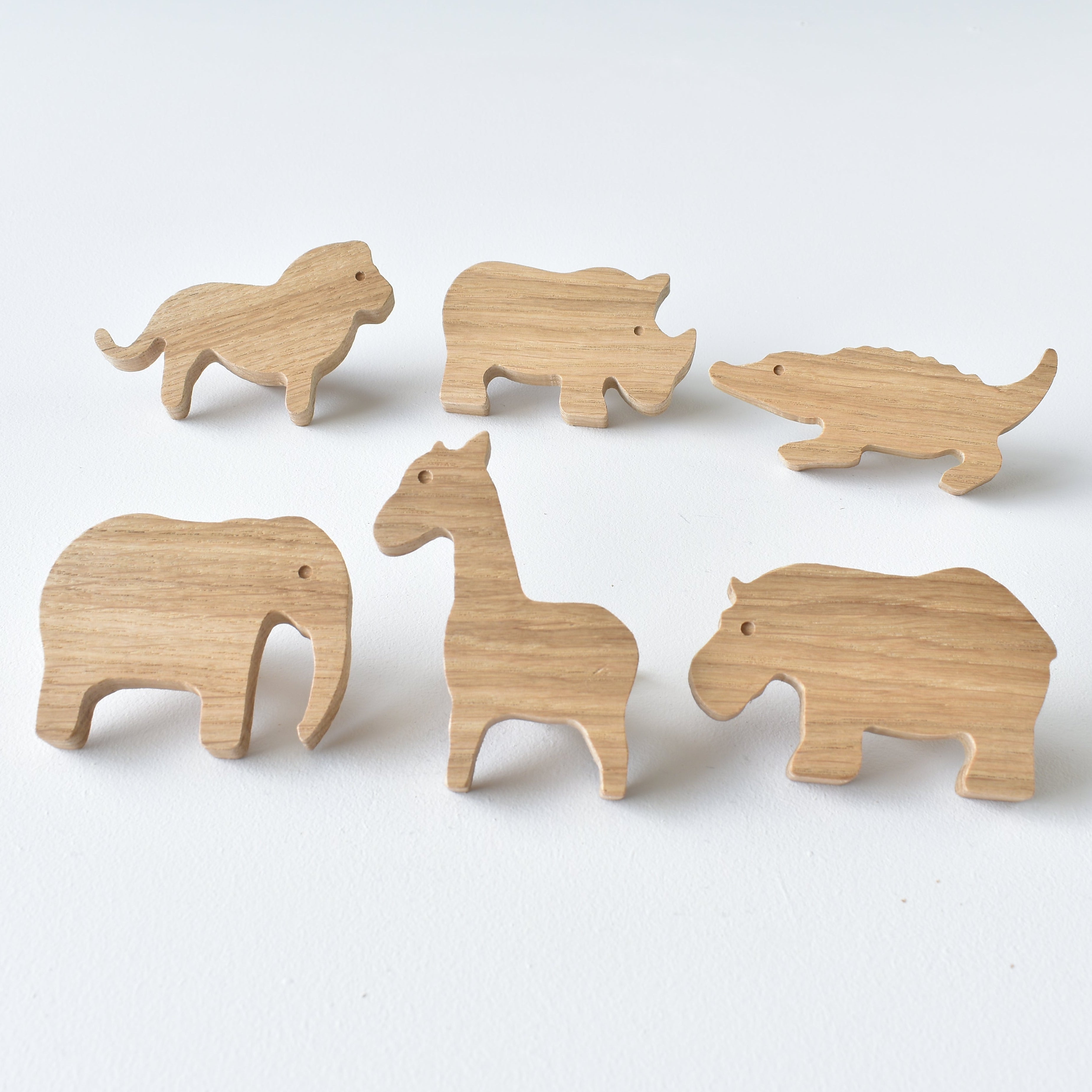 Set of six handmade oak safari animal drawer knobs including lion, rhino, crocodile, elephant, giraffe and hippo