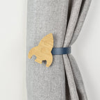 Wooden rocket shaped curtain tieback