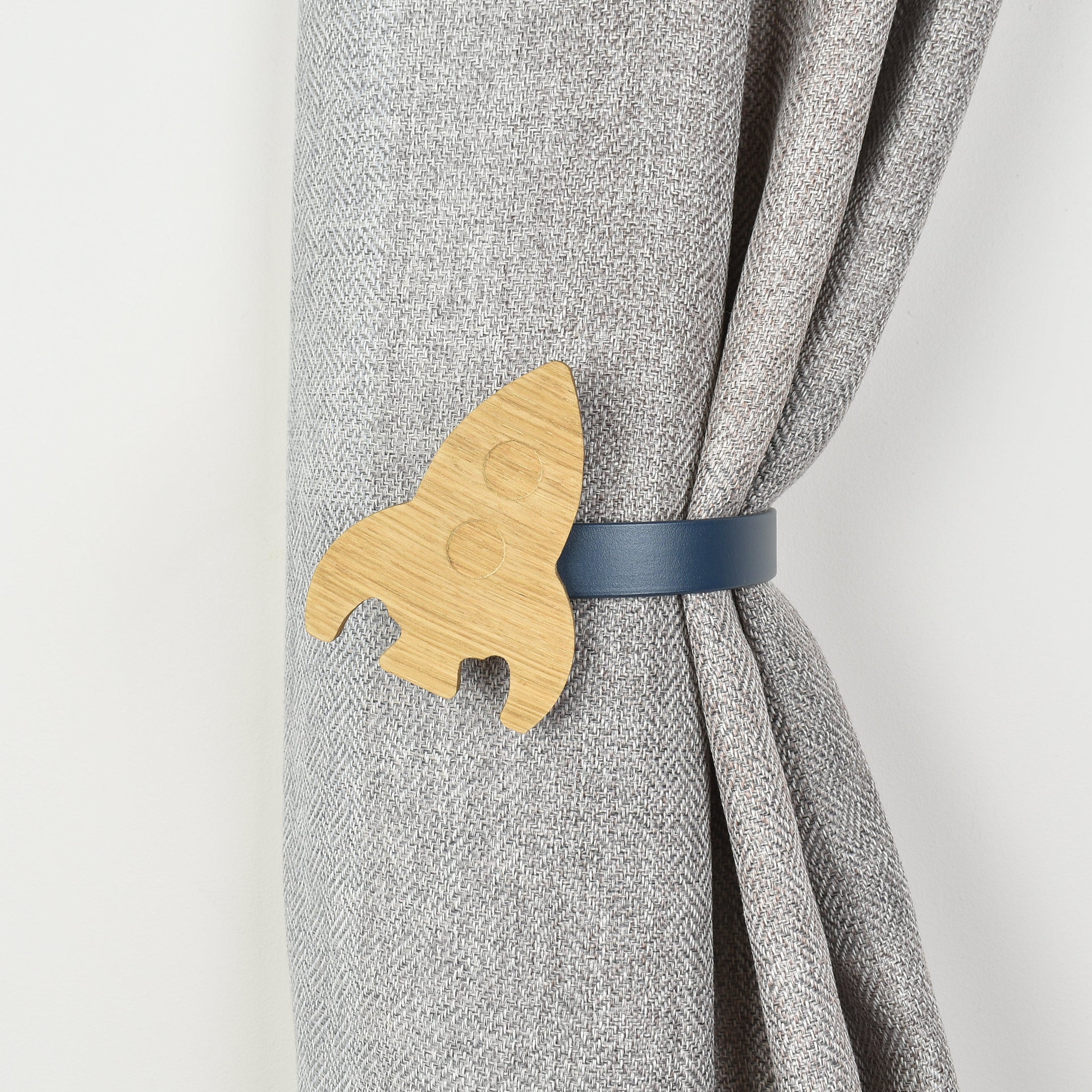 Wooden rocket shaped curtain tieback