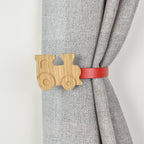 Curtain tieback with wooden train design