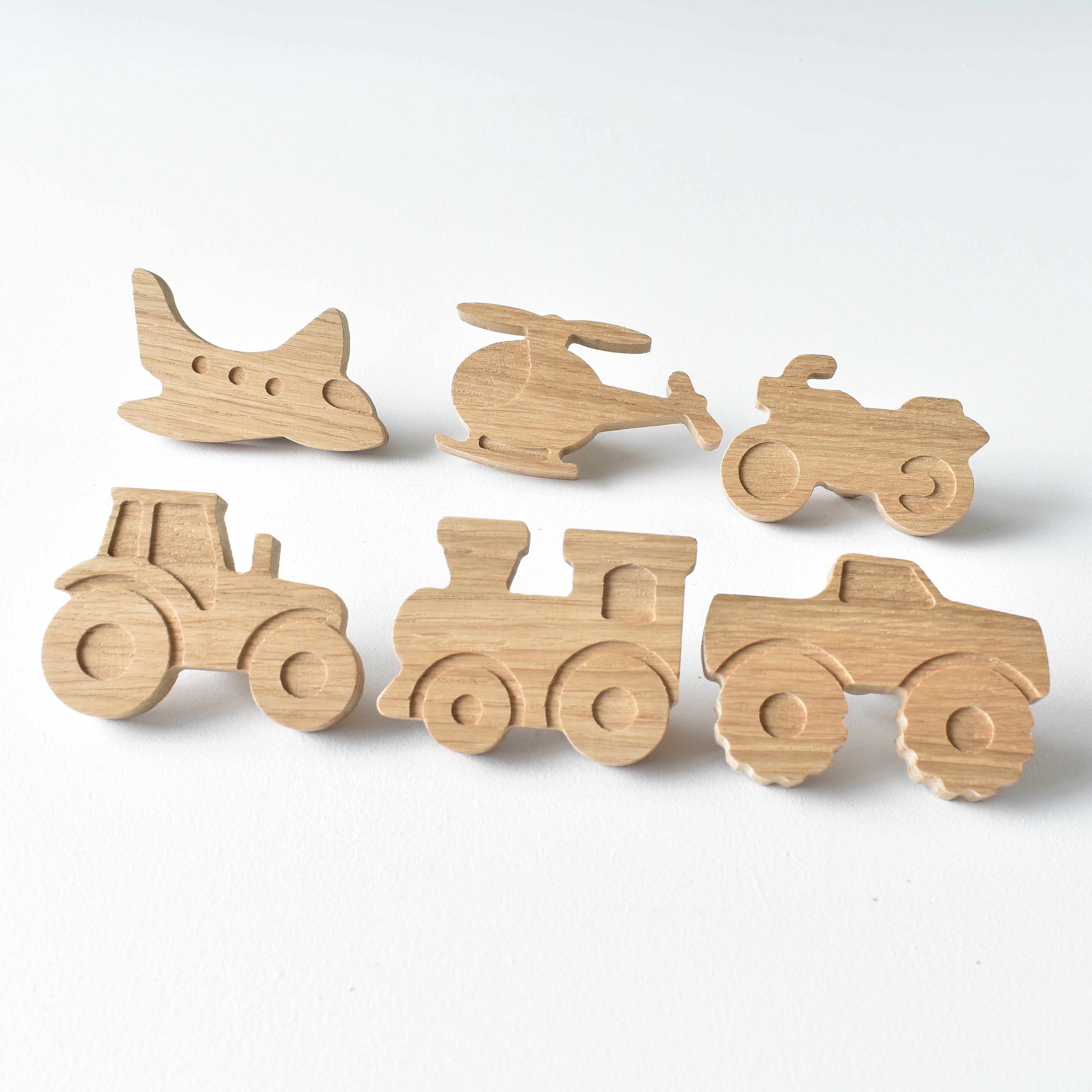 Set of six handmade oak transport vehicle drawer knobs including aeroplane, helicopter, motorbike, tractor, train and monster truck